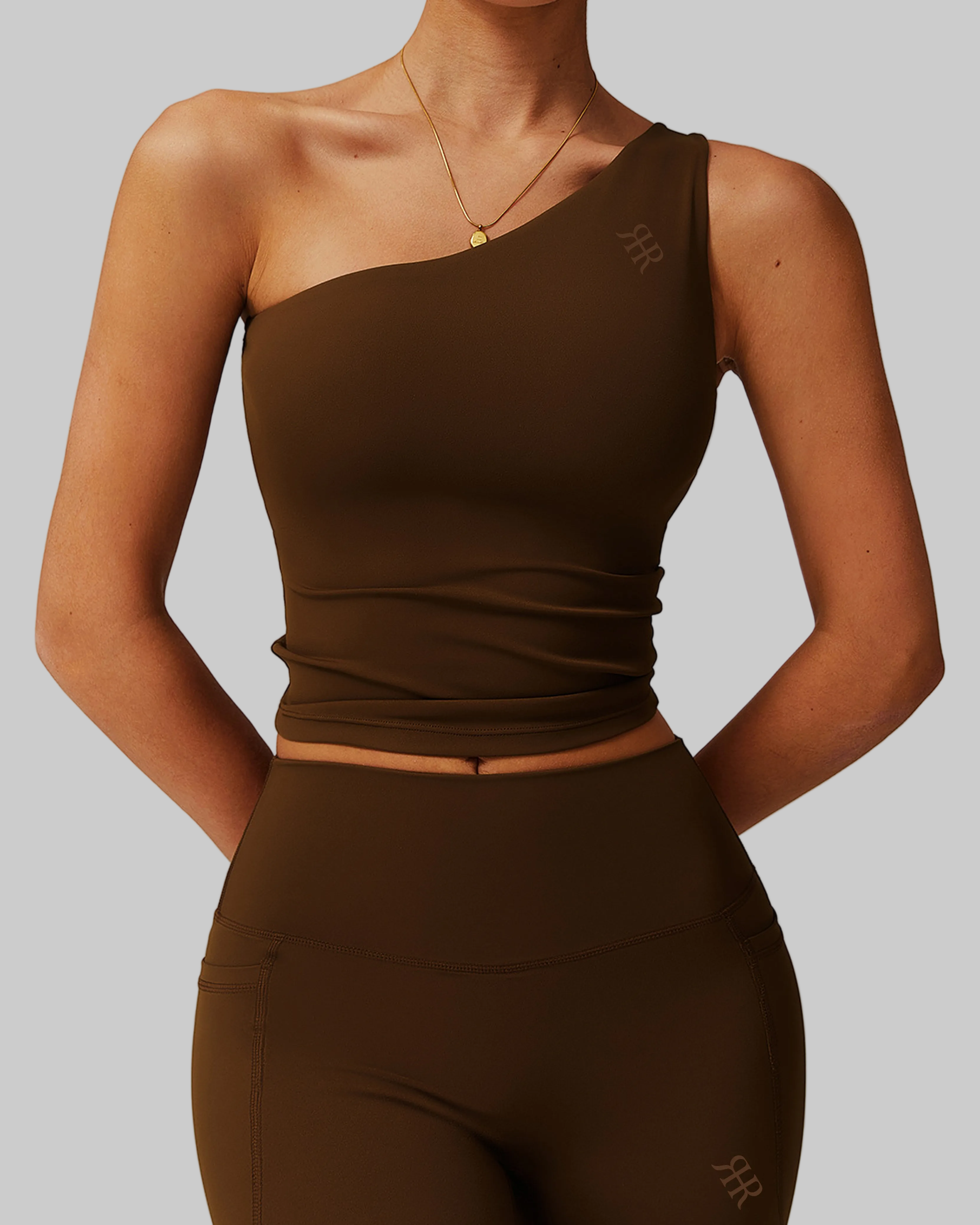 Woman wearing a brown one-shoulder top and shorts set, comfortable activewear for everyday canada