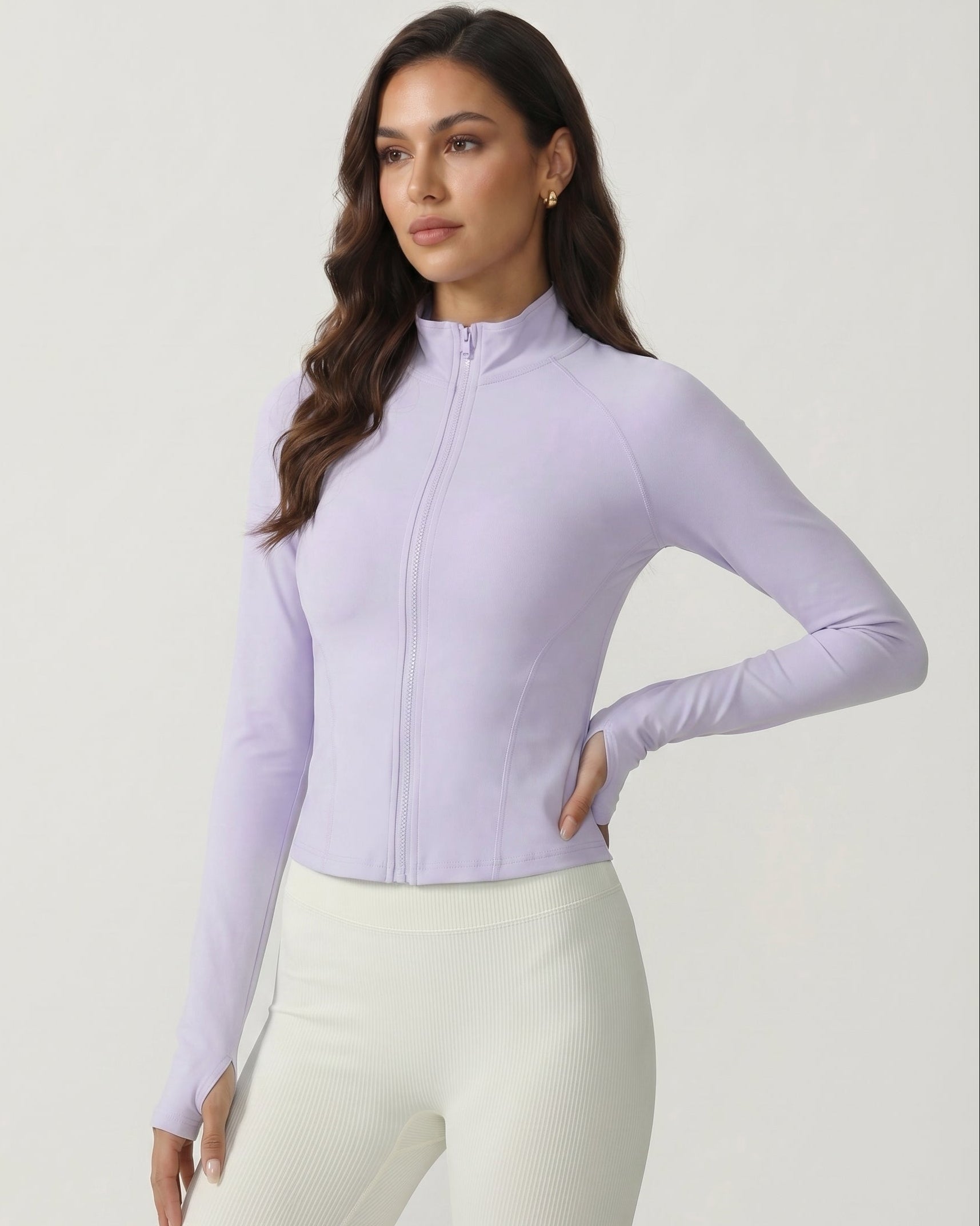Woman wearing a light purple long-sleeve top with a zipper on a white background