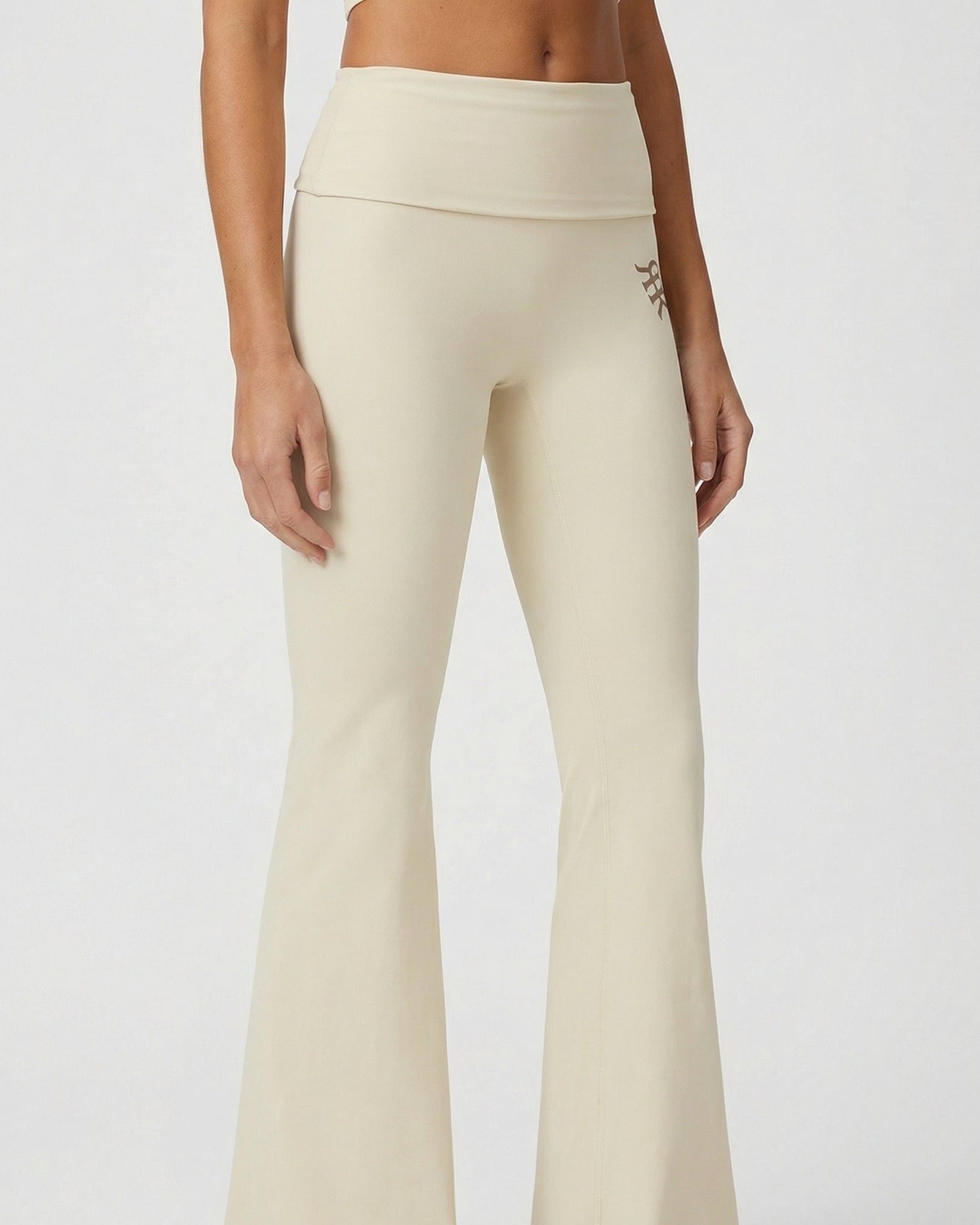 Beige leggings worn by a person on a plain background
