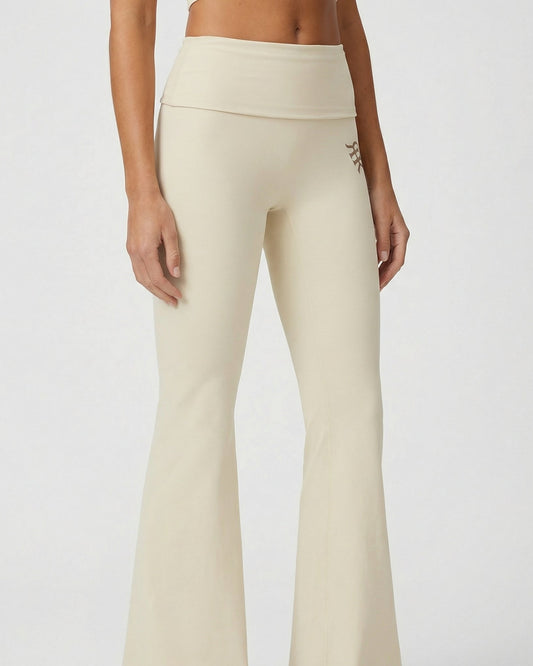 Beige leggings worn by a person on a plain background