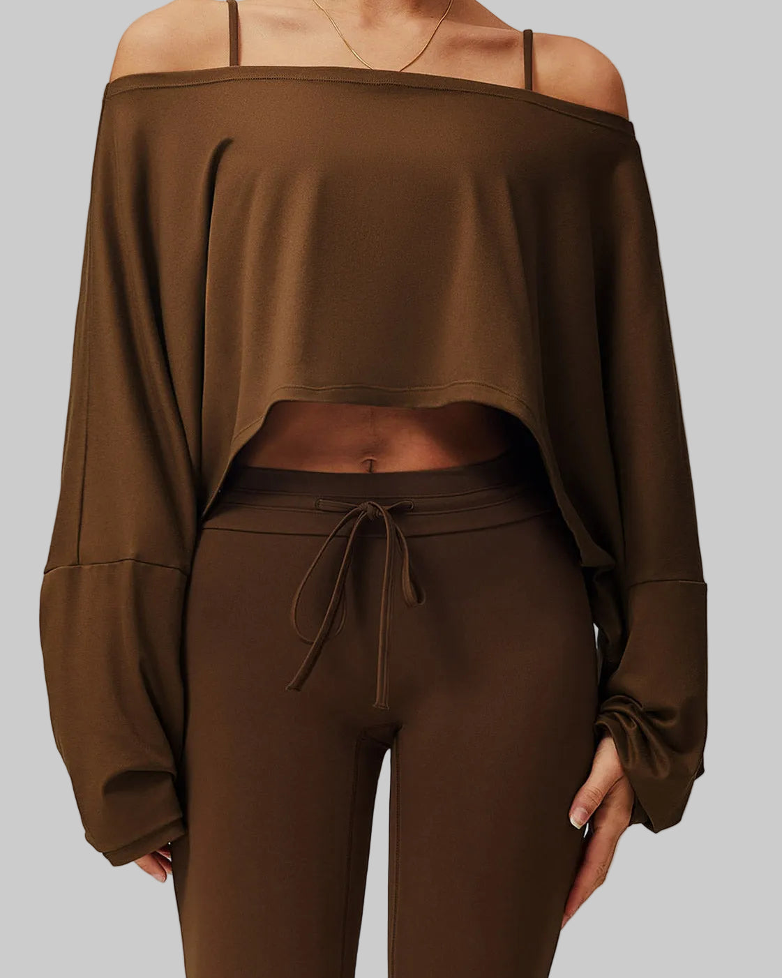 Brown off-shoulder top and pants set on a neutral background