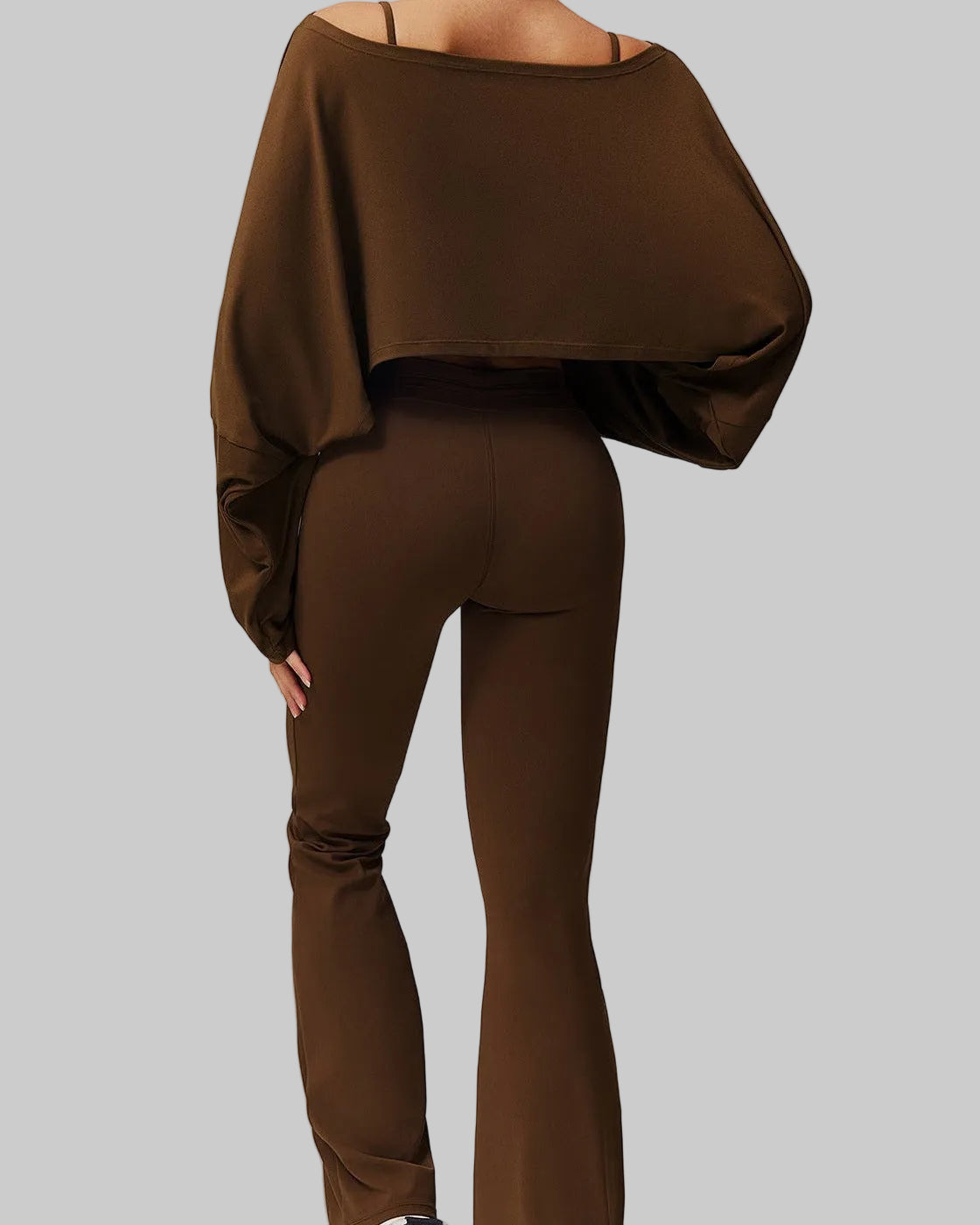 Brown outfit with a loose-fitting top and pants on a plain background