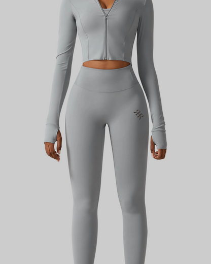 Person wearing a gray athletic outfit on a white background