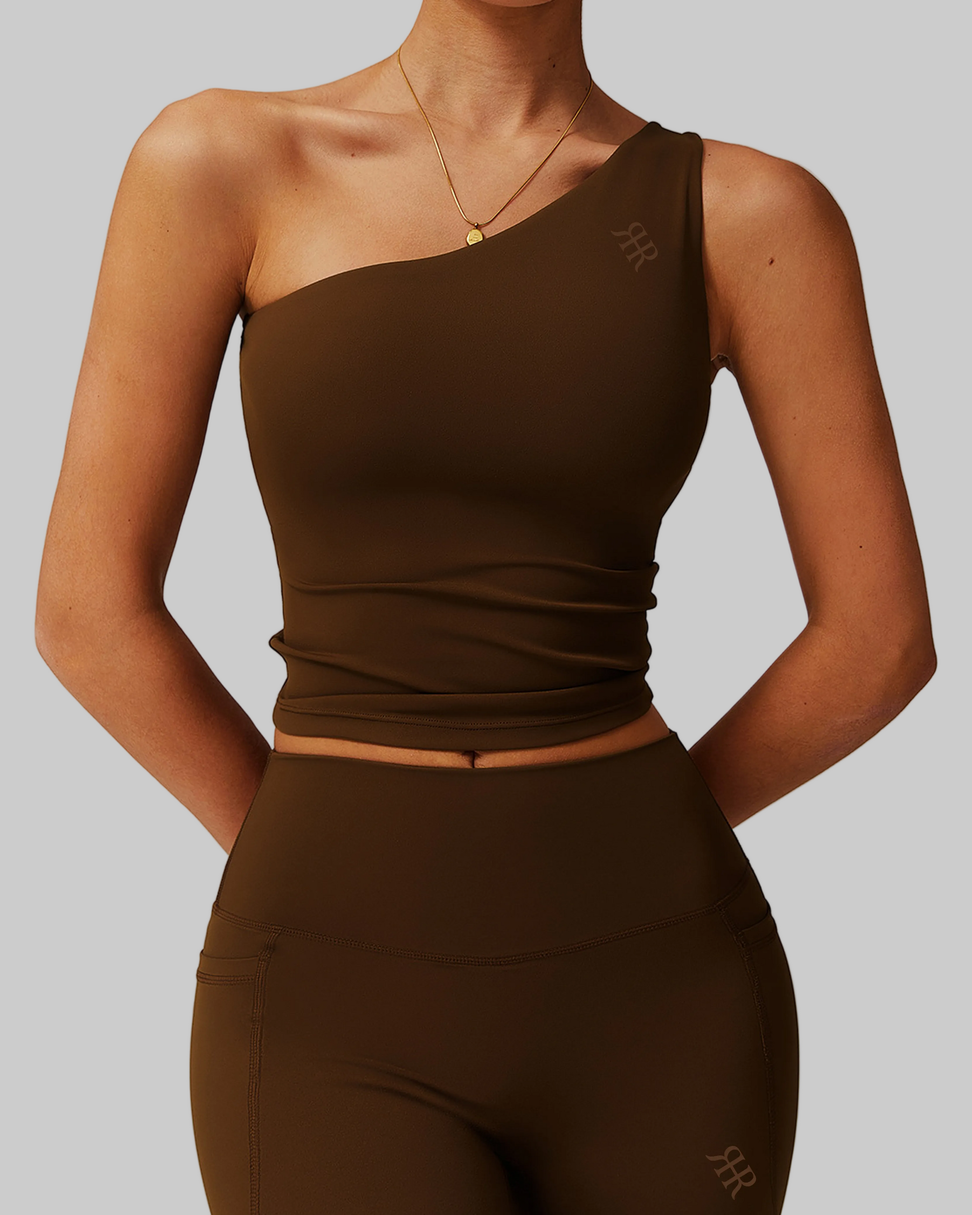 Woman wearing a brown one-shoulder top and shorts set, comfortable activewear for everyday canada