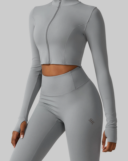 Gray athletic outfit with long-sleeve top and leggings on a light gray background