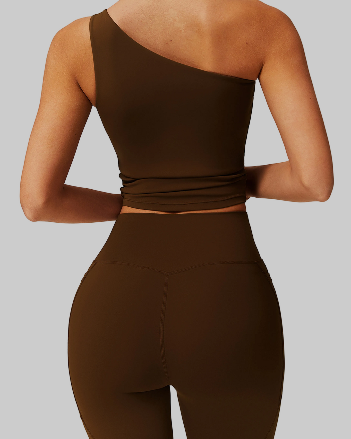 Woman wearing a brown one-shoulder top and shorts set, comfortable activewear for everyday canada