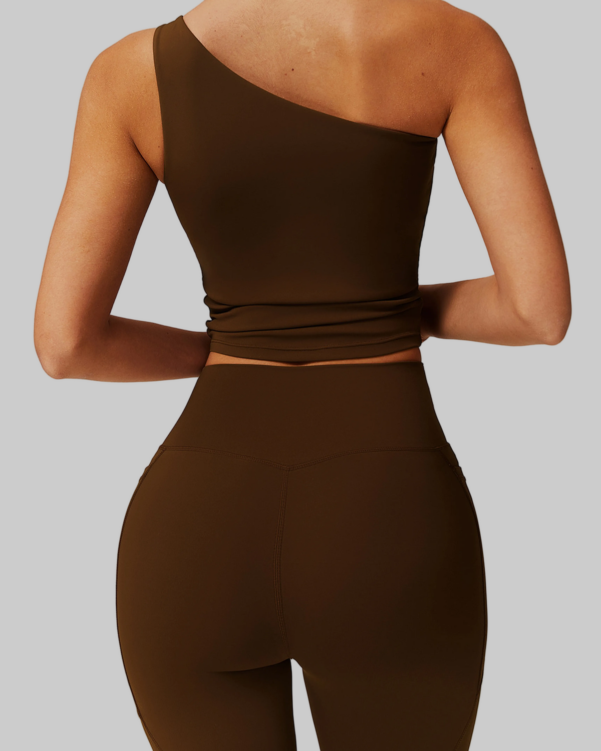 Woman wearing a brown one-shoulder top and shorts set, comfortable activewear for everyday canada