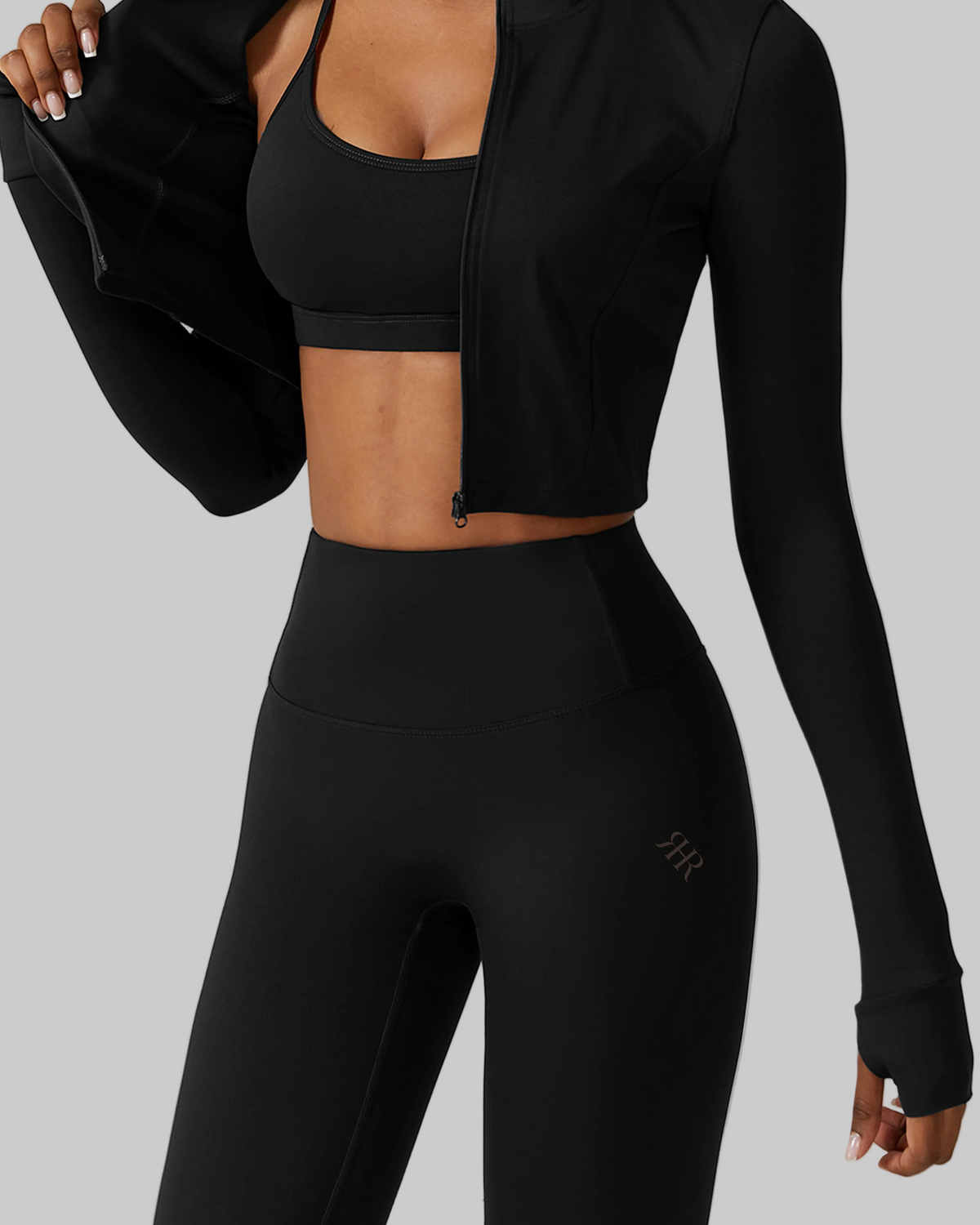 Black athletic outfit with long-sleeve top and leggings on a white background