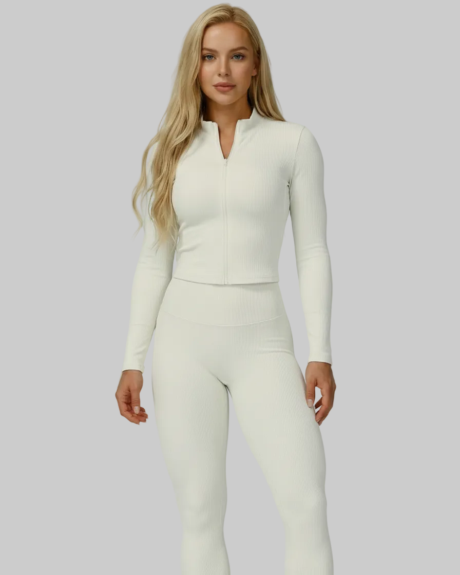 Woman wearing white ribbed compression jacket, racerback tank, and high-waisted leggings from the Soft Power Set.