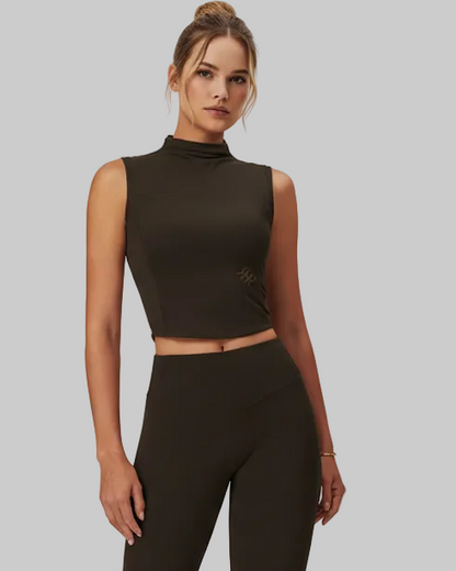 Woman wearing a black sleeveless top and leggings on a white background