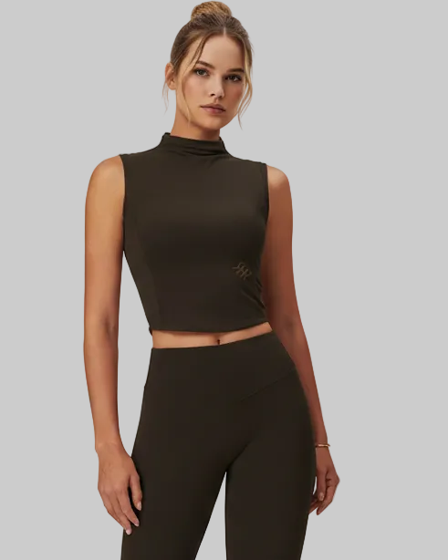 Woman wearing a black sleeveless top and leggings on a white background