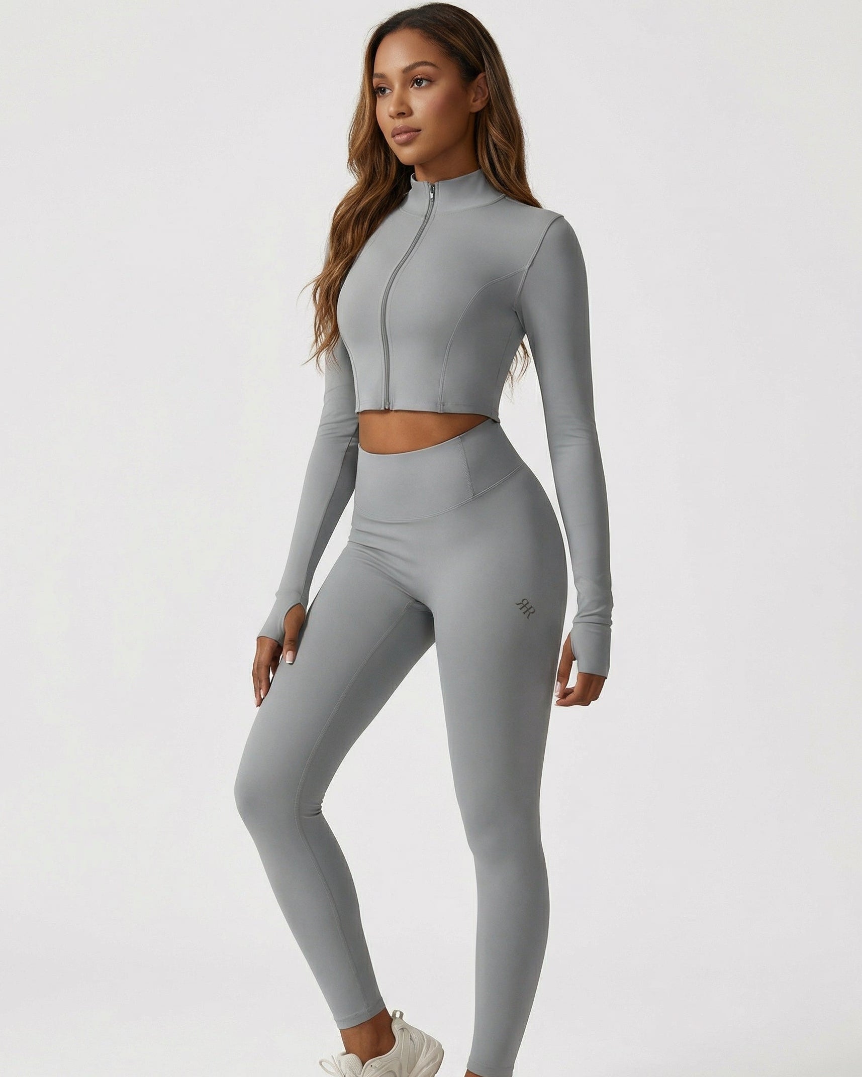 Person wearing a gray athletic outfit on a white background