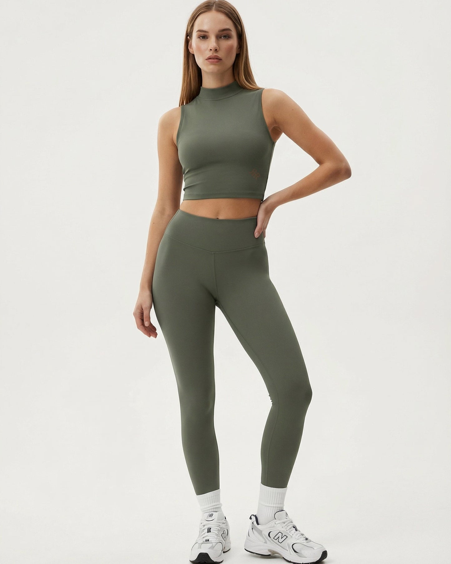Woman wearing a green athletic outfit on a white background