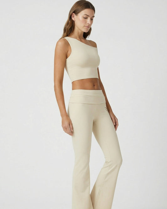 Woman wearing a beige athletic outfit on a white background