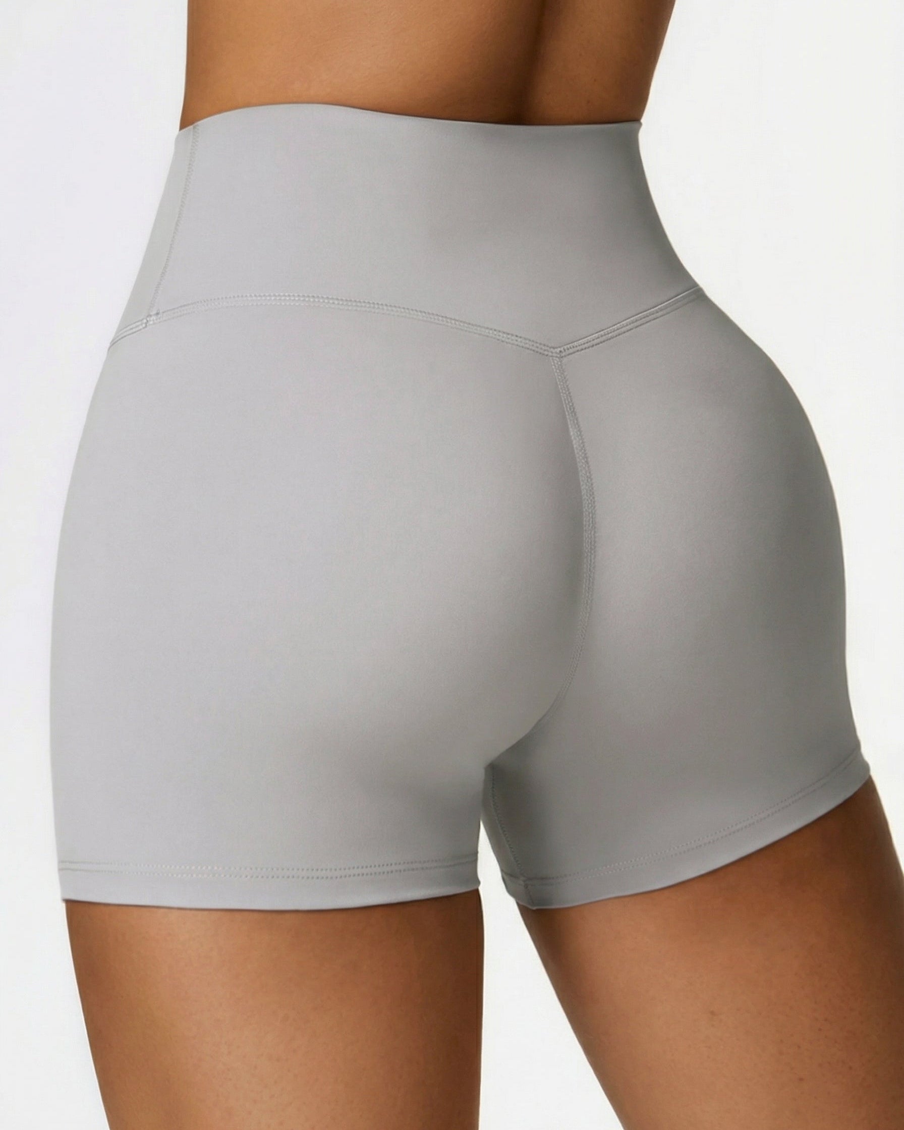 Gray athletic shorts worn by a person on a white background