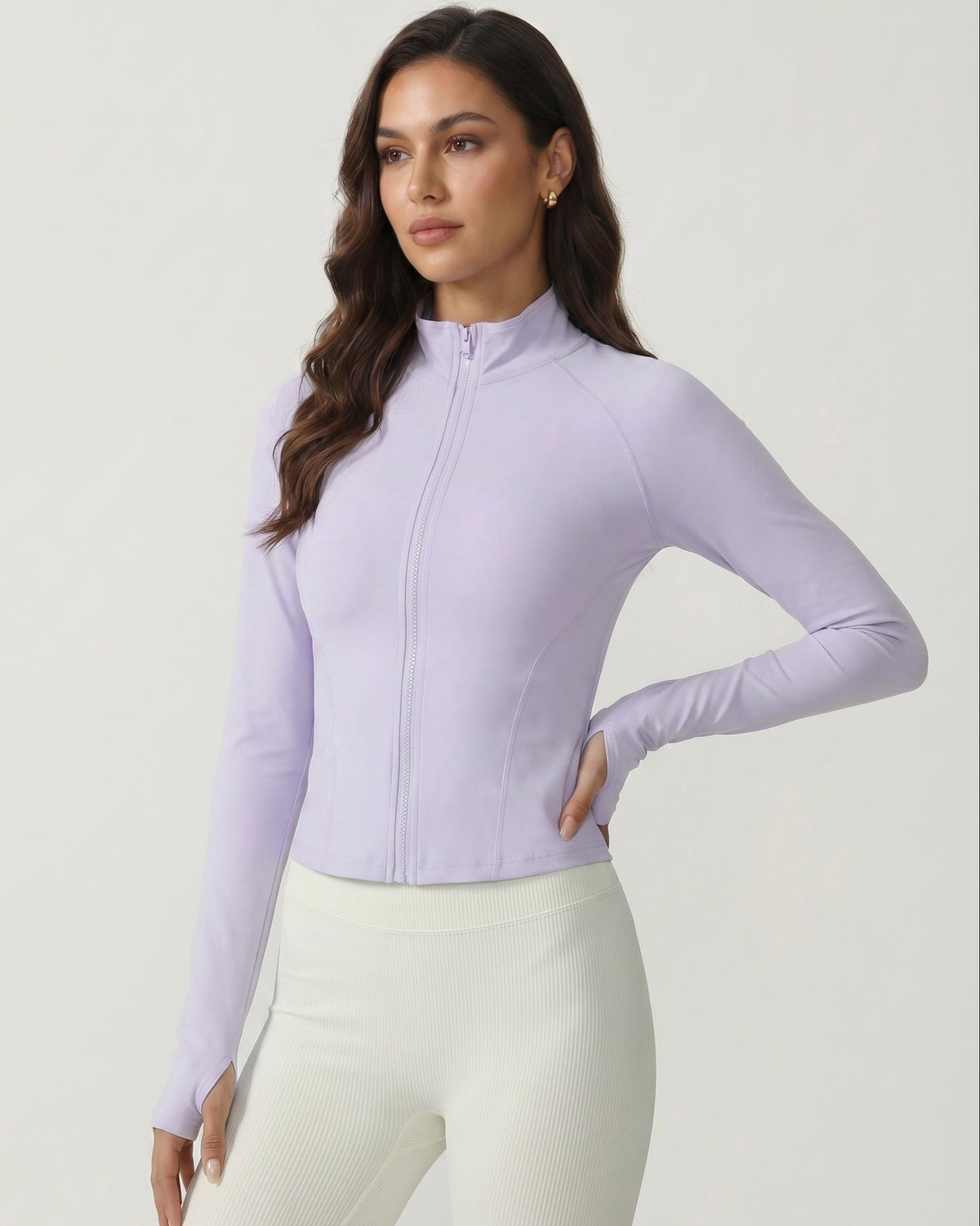 Woman wearing a light purple long-sleeve top with a zipper on a white background